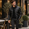 Jacket focused front view of the full Black Alexander Glossy Padded Winter worn by a happy adult model in UK autumn street