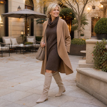ankle boots — Mature woman wearing taupe fold over knee high boots in a garden hotel courtyard — view 8