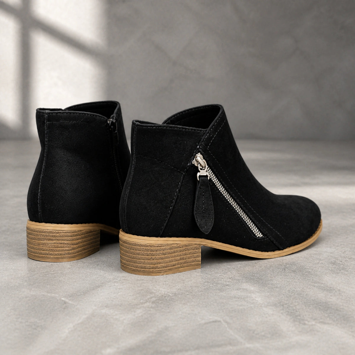 Black suede diagonal zip ankle boots direct rear view — view 8