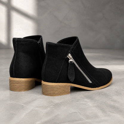 Black suede diagonal zip ankle boots direct rear view — view 8