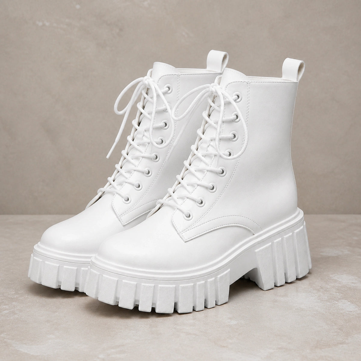 White chunky platform combat ankle boots complete pair front view — view 2