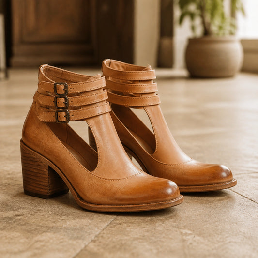 Light tan smooth triple buckle cutout block heel ankle boots complete pair front view