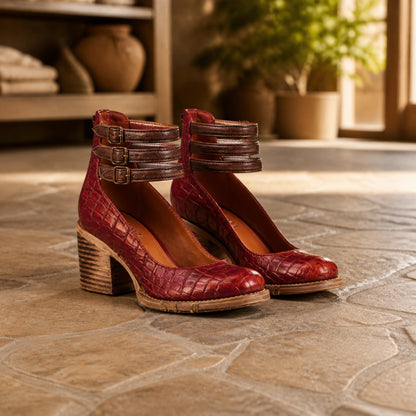 Oxblood reptile texture triple buckle cutout ankle boots complete pair front view — view 6