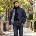 Jacket focused front view of the full Navy Blue Asher Diamond Quilted Zip Pocket worn by a happy adult model in UK autumn