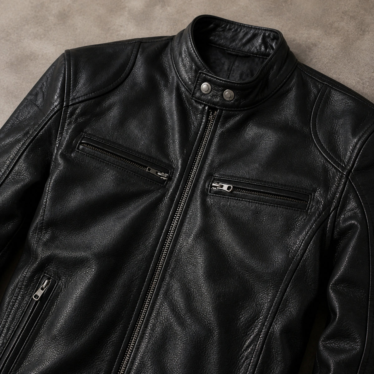 Black faux leather jacket collar chest zippers hand pockets seams and grain detail — view 9
