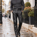 leather trousers — Front view of the full Black trousers worn by an adult model in a cool UK autumn street setting