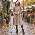 Women's A Line Knit Mid Calf Midi Jumper Dress in Khaki, worn by happy model UK autumn setting