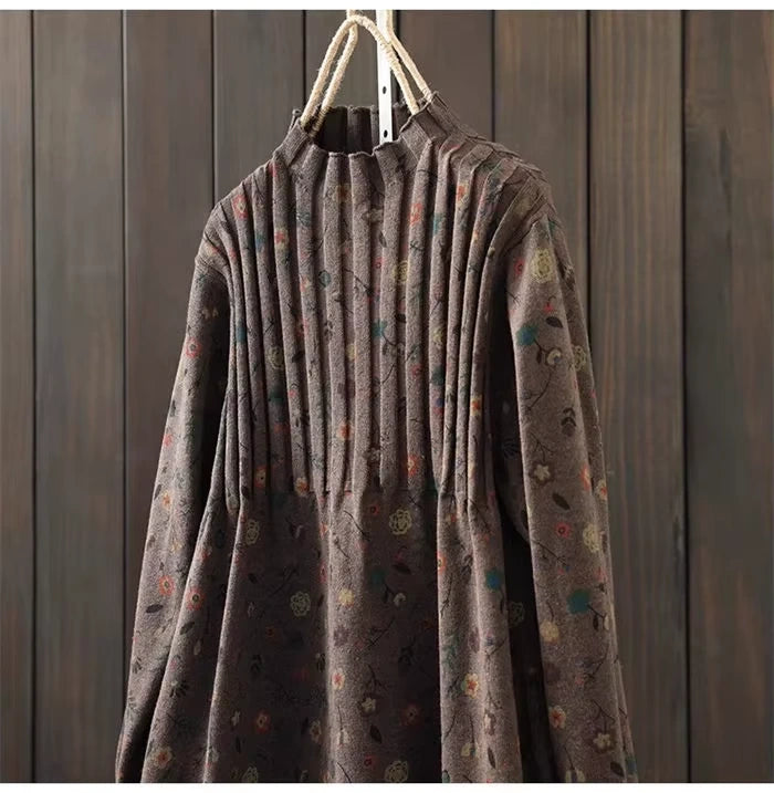 Brown knit midi jumper dress with pleated design and subtle floral pattern, hanging on a wooden background — view — view 32
