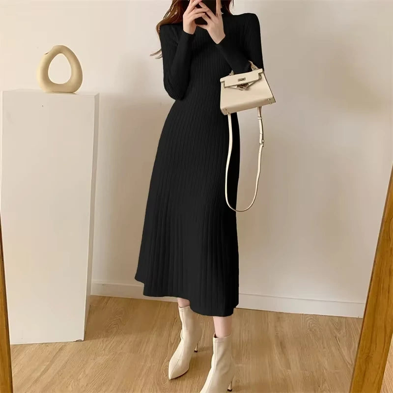 Black knitted A line midi jumper dress with half high collar, shown in room setting — view 30 — view 33