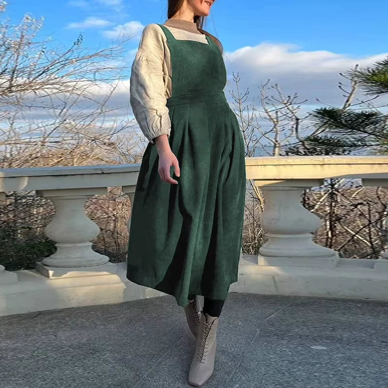 Green corduroy midi jumper dress with square neck and button details, outdoor setting — view 6