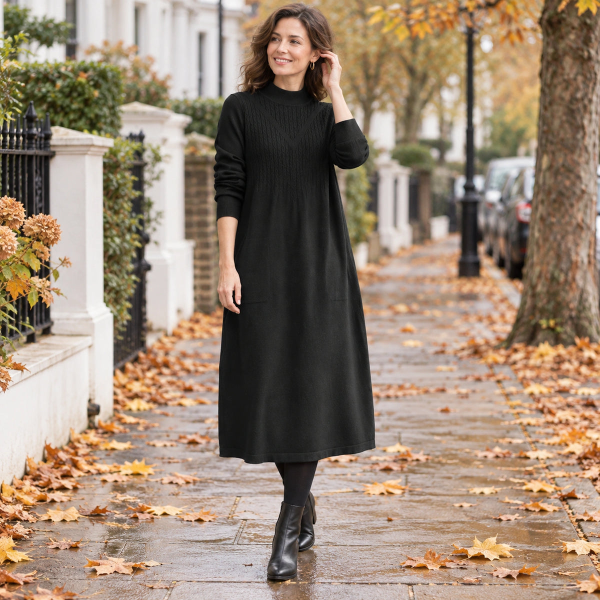 Women's Loose Fit A Line Half High Neck Midi Jumper Dress in Black, worn by happy model UK autumn setting