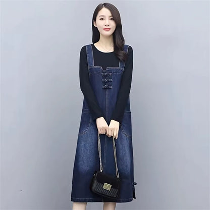 Women's loose fit denim knee length midi jumper dress with front pockets, worn over a black top — view 5 — view 6