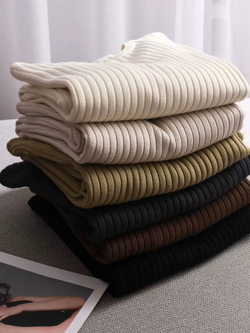 Midi jumper dress — Stack of folded women's knit dresses in various neutral colours, showcasing ribbed — view 20 — view 25