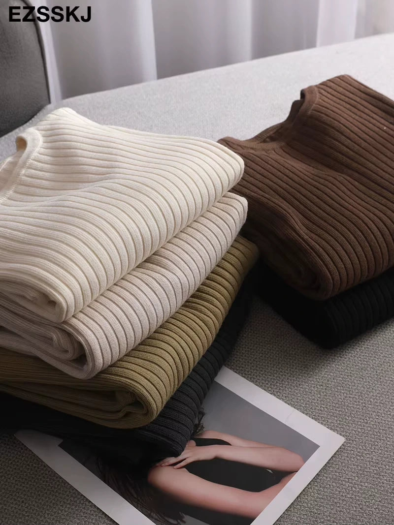 Midi jumper dress — Folded cotton blend knit dresses in cream, brown, olive, and black on a grey surface — view 3 — view 8
