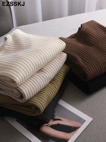 Midi jumper dress — Folded cotton blend knit dresses in cream, brown, olive, and black on a grey surface — view 3 — view 8