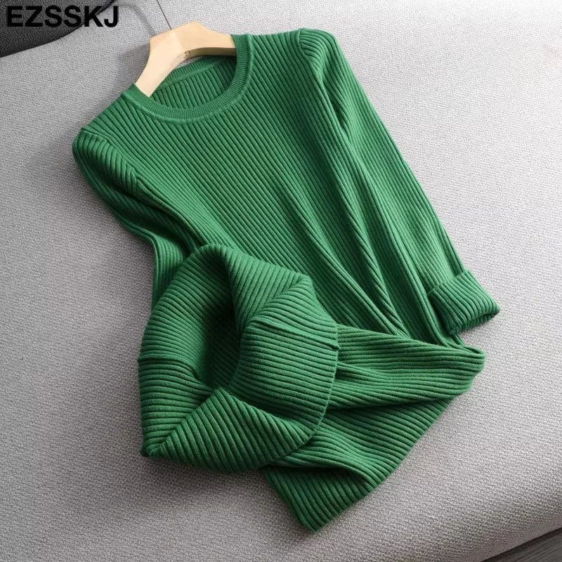 Green knit midi jumper dress with O neck and slim fit design, laid flat on a sofa — view 4 — view 9