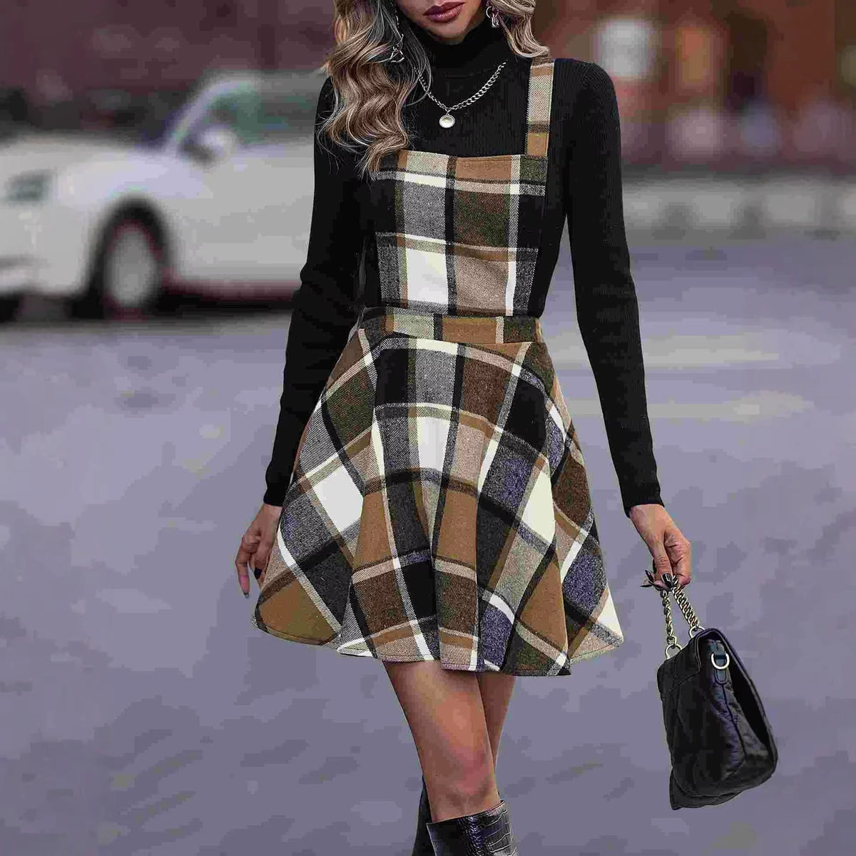 Women's tartan A line knee length midi jumper dress with plaid pattern, worn over black top — view 2 — view 3