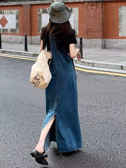 Woman wearing a blue denim midi jumper dress with zip detail, walking outdoors — view 2 — view 3