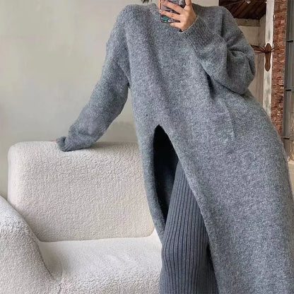Grey loose fit knitted midi jumper dress with long sleeves, displayed on a textured sofa — view 11 — view 15