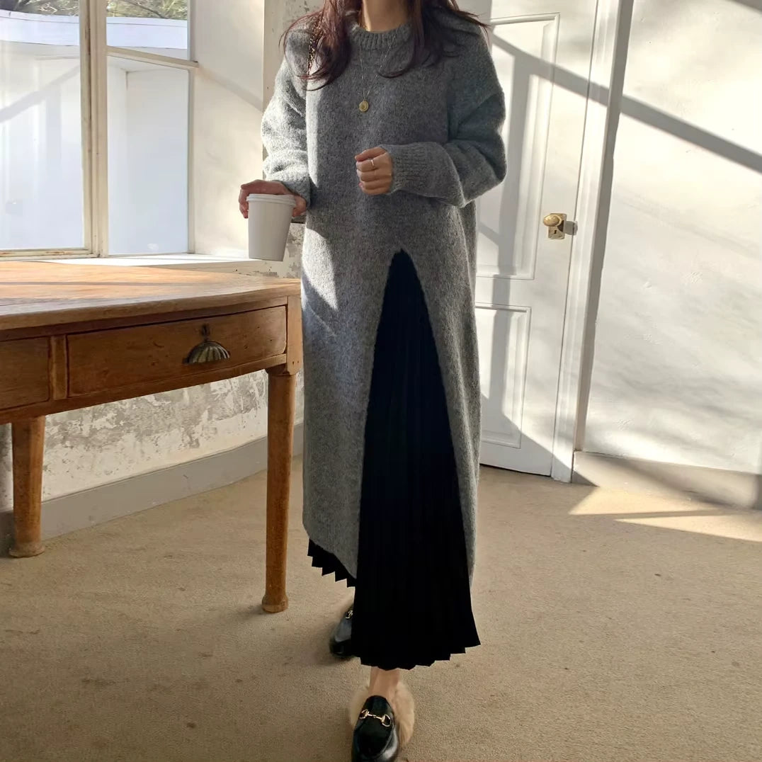A woman wearing grey knitted midi jumper dress with black pleated skirt detail — view 3 — view 7