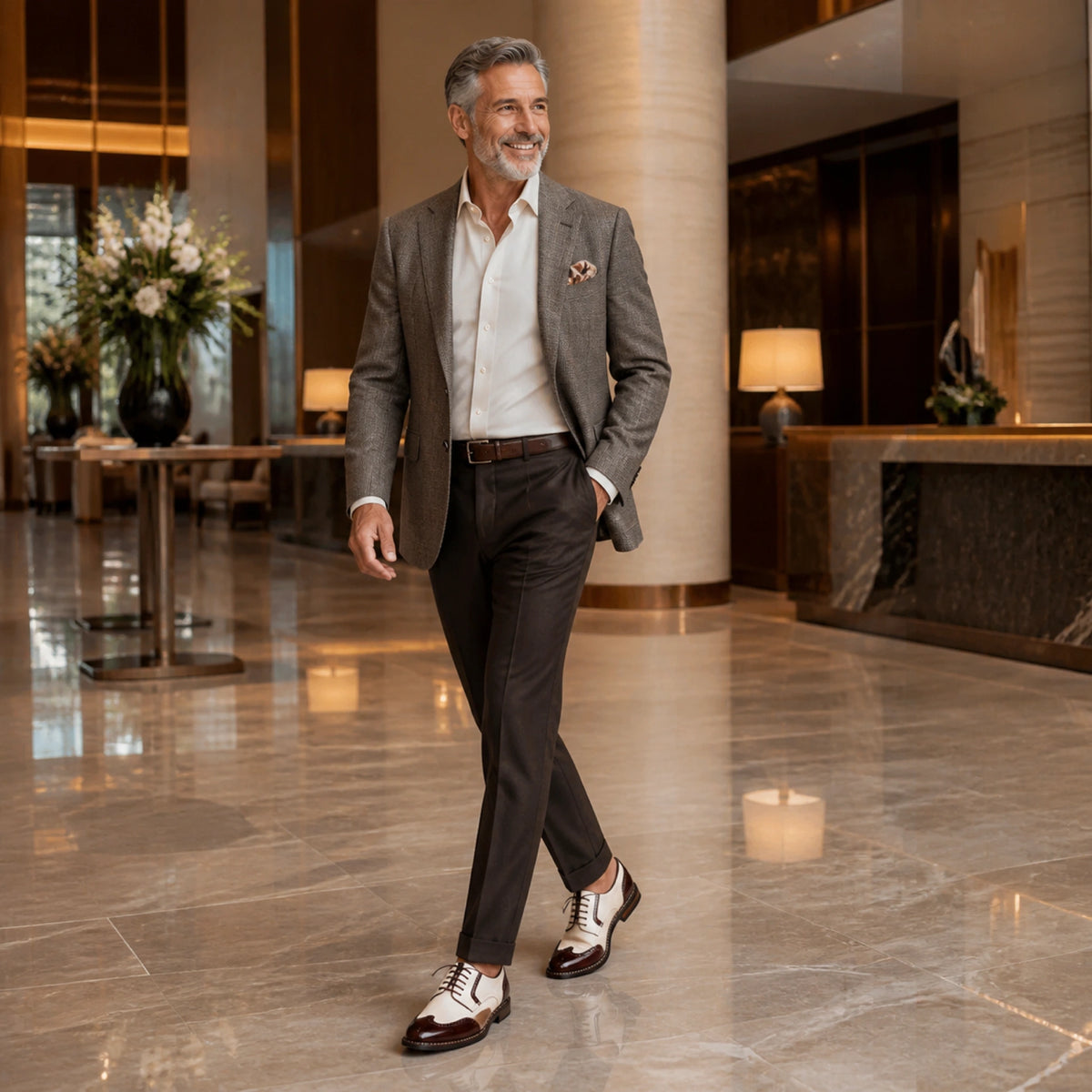 Mature man wearing cream and burgundy Oxford shoes in a hotel — view 7