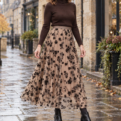 pleated skirt — Front view of the full Khaki skirt worn by an adult model in a cool UK autumn street setting