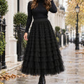 pleated skirt — Front view of the full Black skirt worn by an adult model in a cool UK autumn street setting