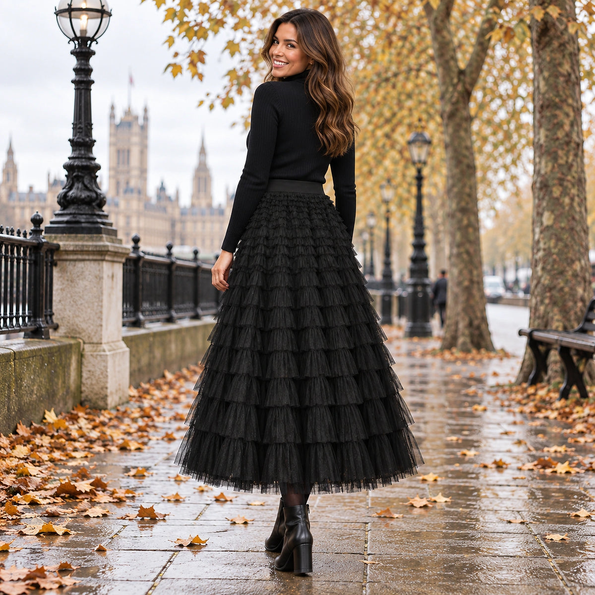 pleated skirt — Back full length view of the Black garment worn by a happy adult model in cool UK autumn setting — view 16