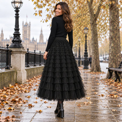 pleated skirt — Back full length view of the Black garment worn by a happy adult model in cool UK autumn setting — view 16