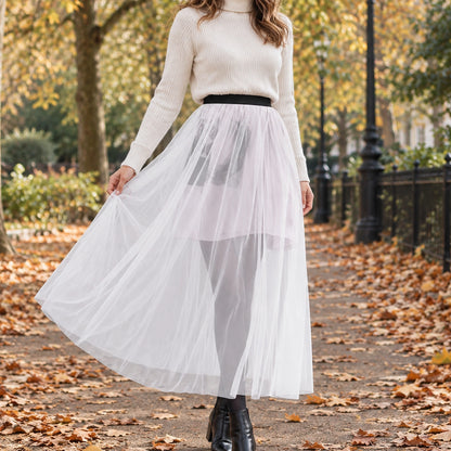 pleated skirt — Front view of the full Single layer White skirt worn by an adult model in a cool UK autumn street — view 7
