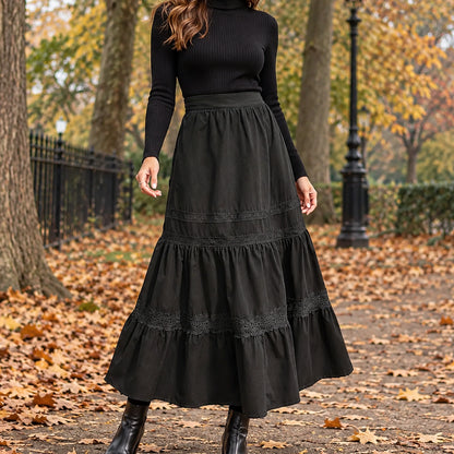 pleated skirt — Front view of the full Black skirt worn by an adult model in a cool UK autumn street setting