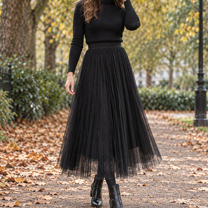 pleated skirt — Front view of the full Black skirt worn by an adult model in a cool UK autumn street setting — view 2