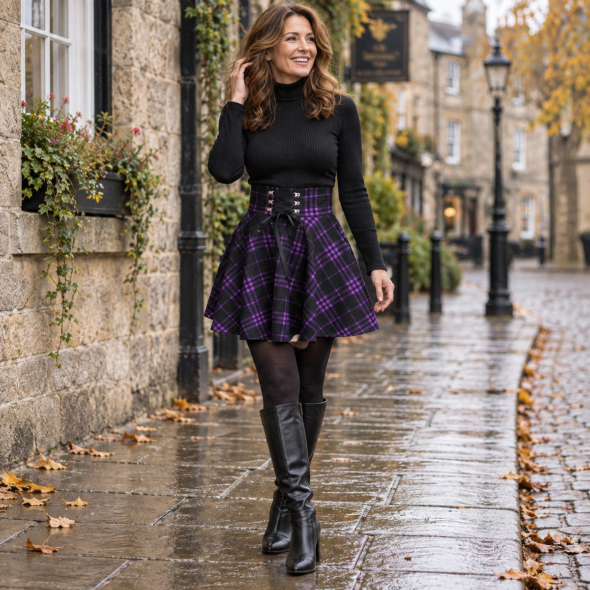 Happy adult model wearing the full Purple Plaid Hazel Lace Up High Rise A Line Mini Pleated Skirt in cool UK autumn — view 10