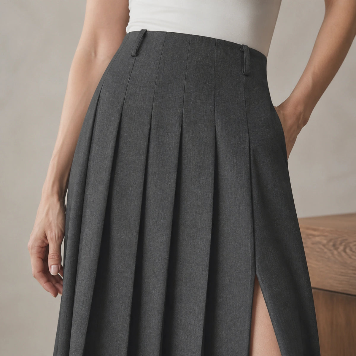 Dark charcoal pleated skirt waistband pleats and slit detail — view 4