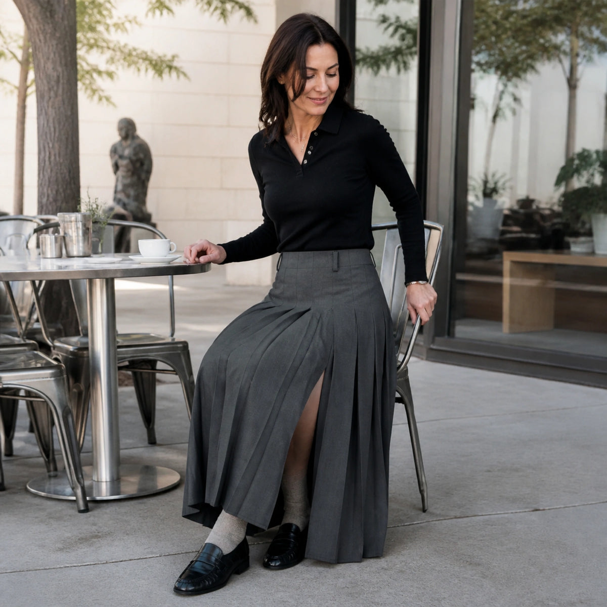 pleated skirt — Woman in her forties wearing a charcoal pleated maxi skirt at museum cafe — view 6