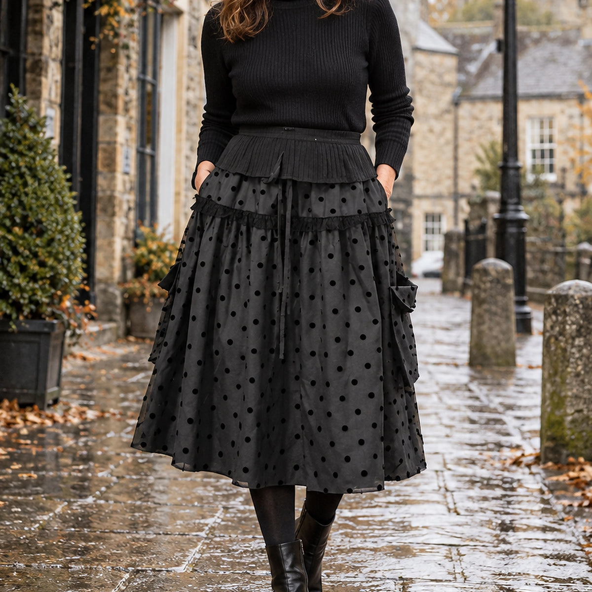 pleated skirt — Front view of the full Black Ruffle skirt worn by an adult model in a cool UK autumn street setting