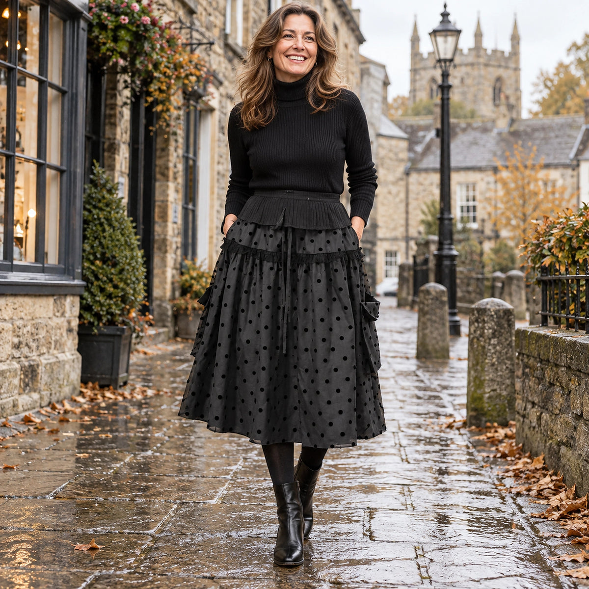 Happy adult model wearing the full Black Ruffle Lily Polka Dot A Line Mid Calf with Pockets Pleated Skirt in cool UK — view 4