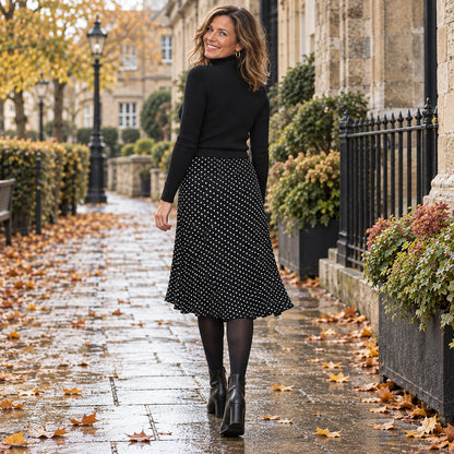 pleated skirt — Back full length view of the Black garment worn by a happy adult model in cool UK autumn setting — view 4