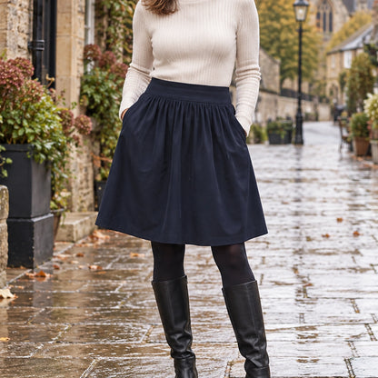 pleated skirt — Front view of the full Navy skirt worn by an adult model in a cool UK autumn street setting — view 2