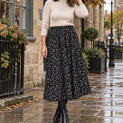 pleated skirt — Front view of the full Black Floral skirt worn by an adult model in a cool UK autumn street setting — view 2