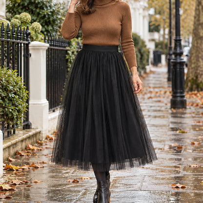 pleated skirt — Front view of the full Black 78 cm skirt worn by an adult model in a cool UK autumn street setting — view 18