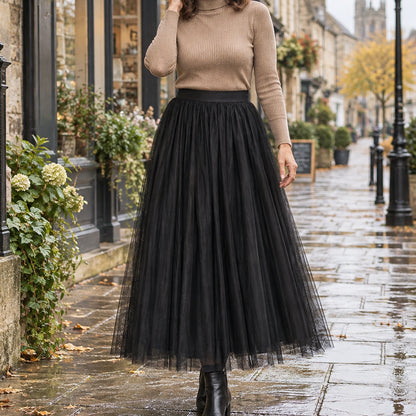 pleated skirt — Front view of the full Black 98 cm skirt worn by an adult model in a cool UK autumn street setting — view 20