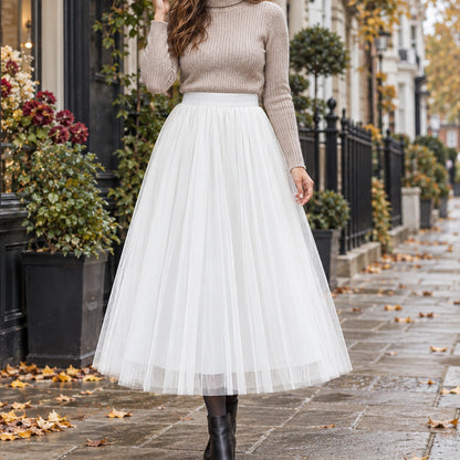 pleated skirt — Front view of the full White 88 cm skirt worn by an adult model in a cool UK autumn street setting — view 23