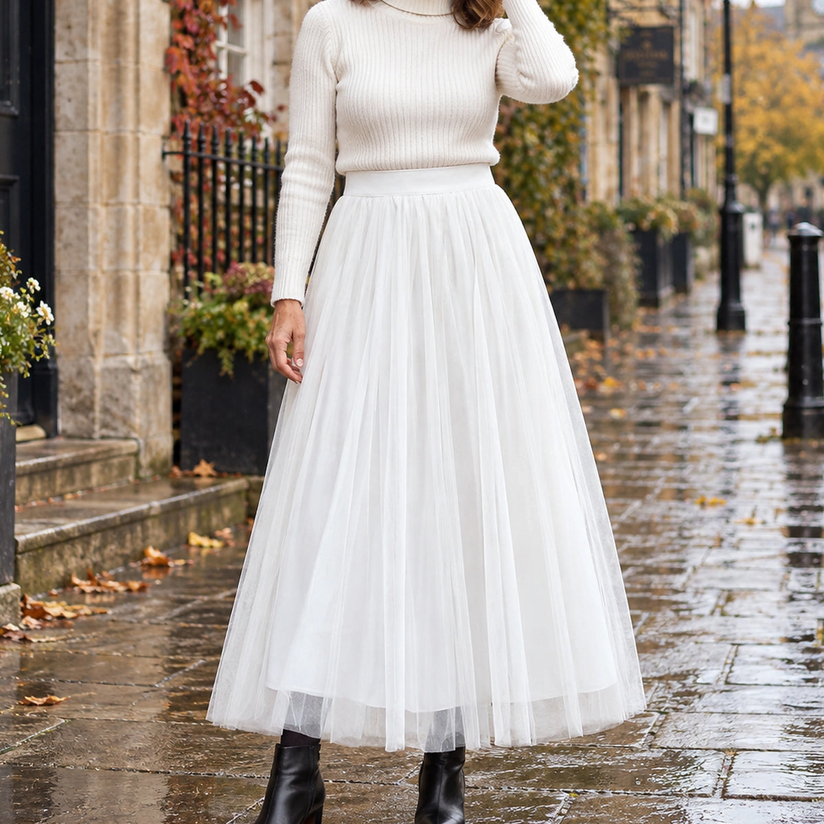 pleated skirt — Front view of the full White 98 cm skirt worn by an adult model in a cool UK autumn street setting — view 24
