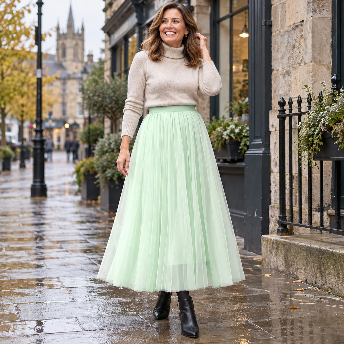 Happy adult model wearing the full Green Violet High Waisted A Line Tulle Pleated Skirt in cool UK autumn setting — view 36