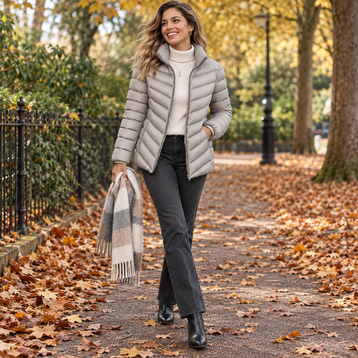 Happy adult model wearing the full Grey Charlotte Stand Collar Lightweight Puffer Jacket in a cool UK autumn — view 13