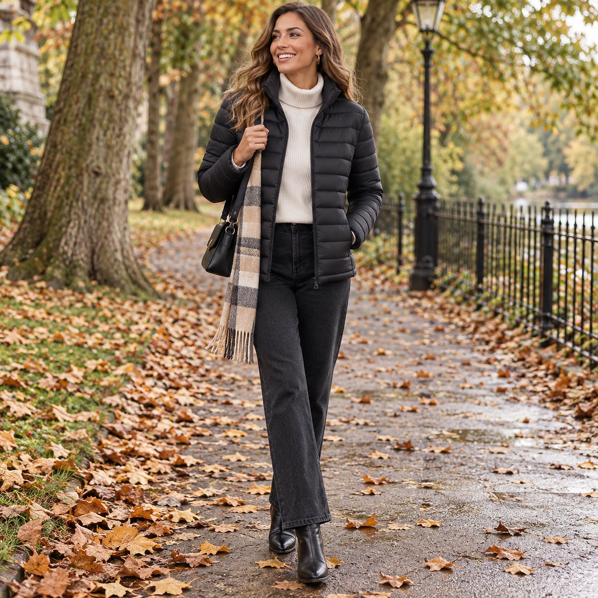 Happy adult model wearing the full Black Charlotte Stand Collar Lightweight Puffer Jacket in a cool UK autumn — view 9