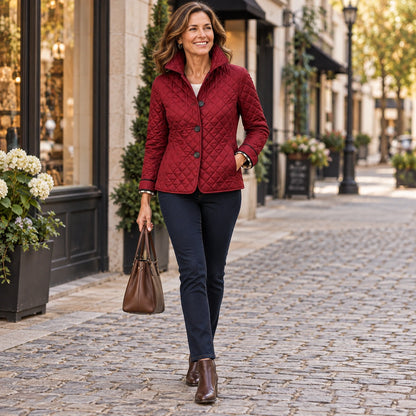 Happy adult model wearing the full Burgundy Lily Diamond Quilted Check Cuff Puffer Jacket in a cool UK autumn — view 9