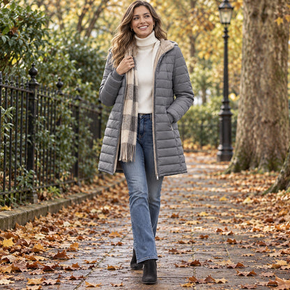 Happy adult model wearing the full Grey Lily Hooded Ribbed Cuff Longline Puffer Jacket in a cool UK autumn setting — view 10