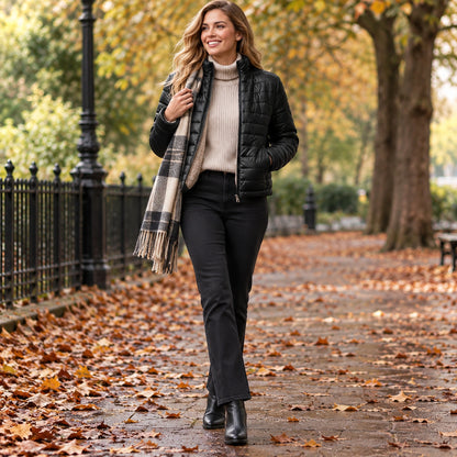 Happy adult model wearing the full Black Ruby Cropped Teddy Lined Quilted Puffer Jacket in a cool UK autumn setting — view 4